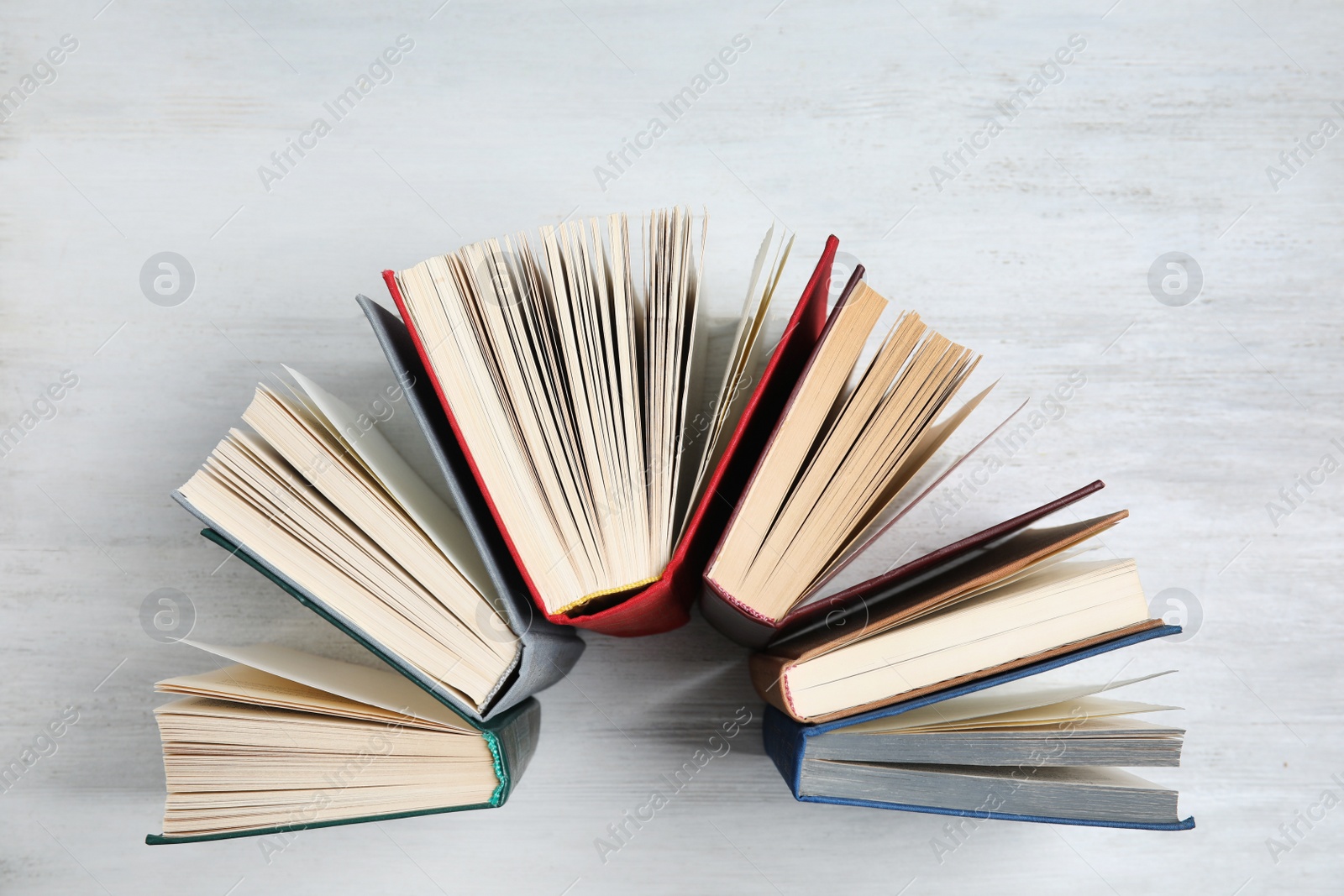 Photo of Hardcover books on white wooden background, flat lay