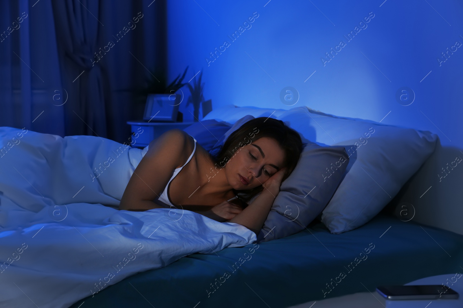 Photo of Young woman suffering from insomnia at home. Bedtime