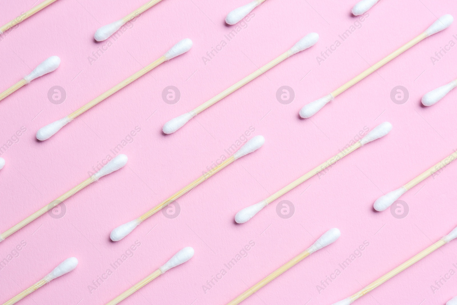 Photo of Many cotton buds on pink background, flat lay