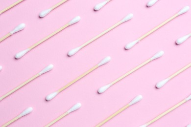 Photo of Many cotton buds on pink background, flat lay