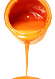 Pouring orange paint from can on white background, closeup