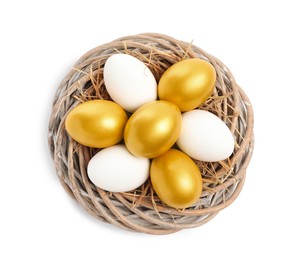 Photo of Nest with golden and ordinary chicken eggs on white background, top view