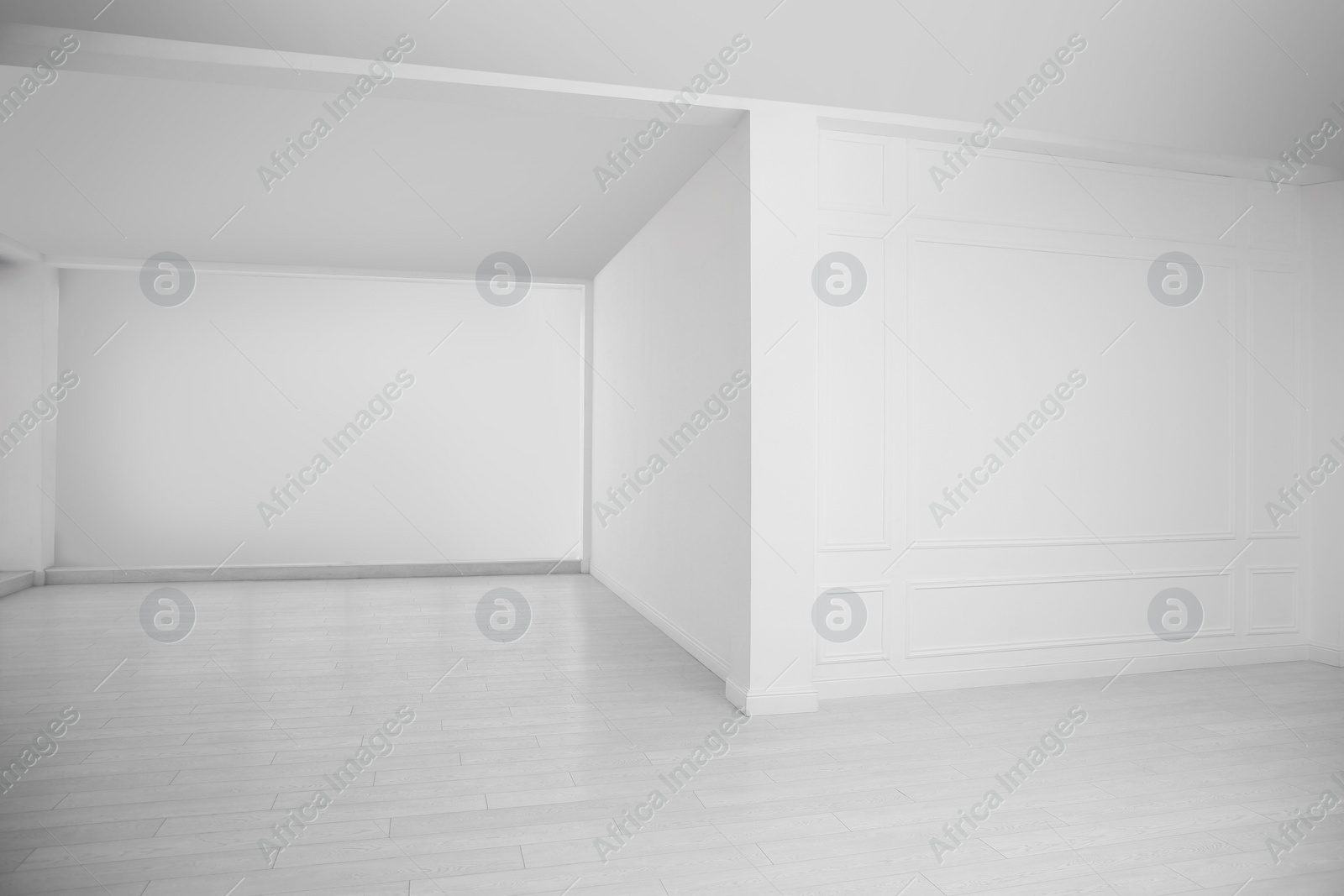 Photo of Empty room with white walls and laminated floor