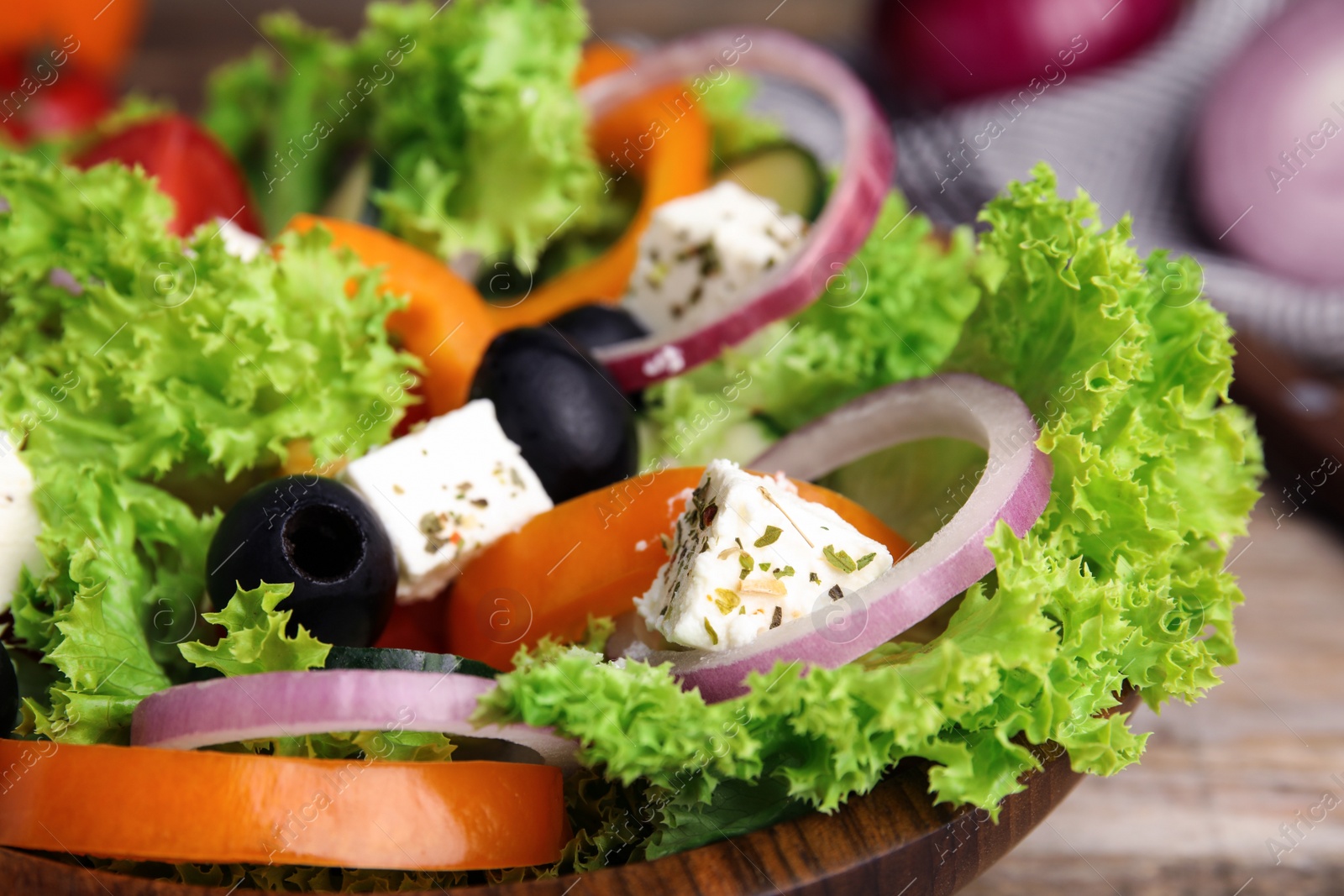 Photo of Plate of tasty fresh Greek salad on table, closeup