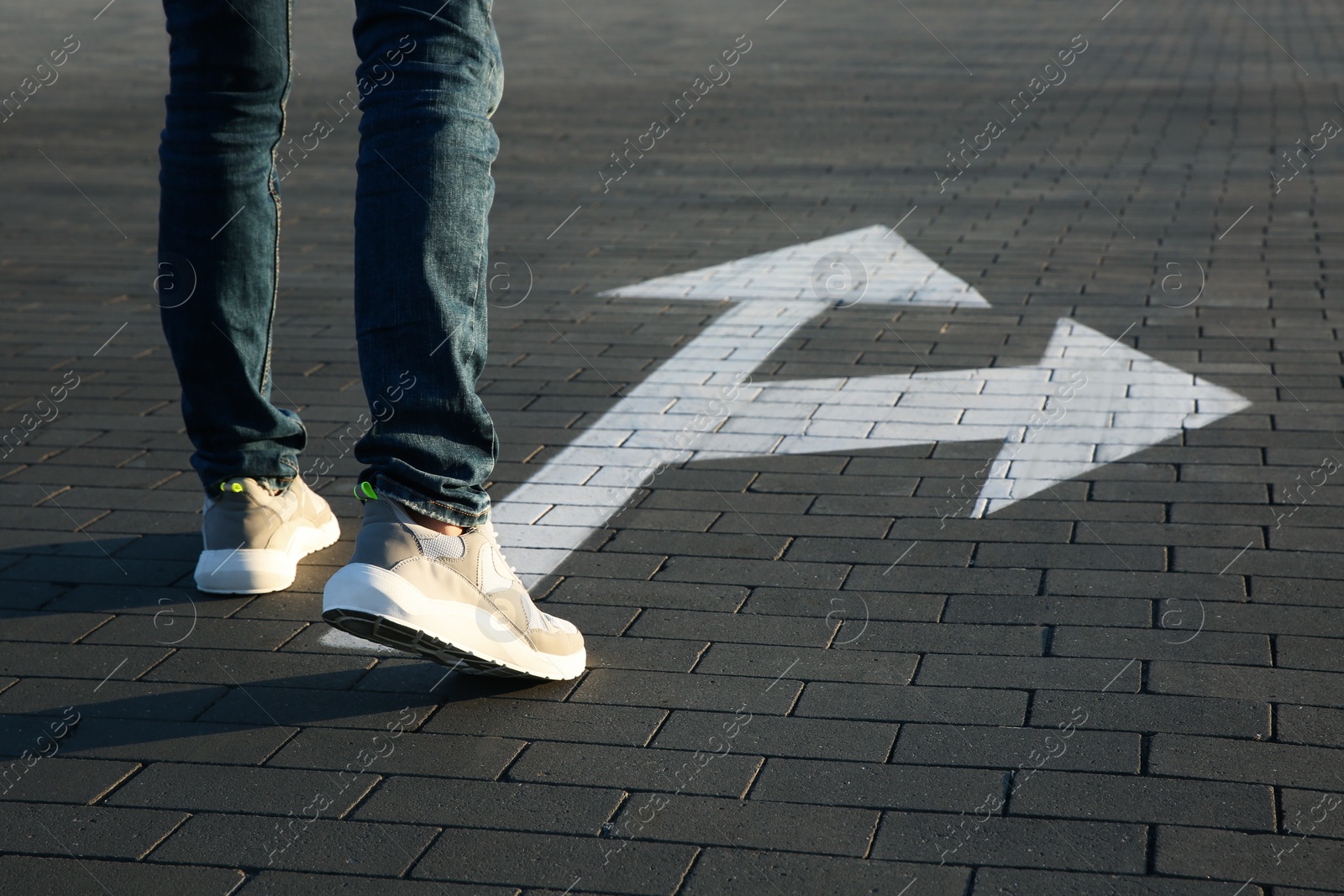 Photo of Man going along road with arrows marking, closeup