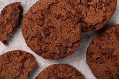 Tasty chocolate cookies on light grey textured table, closeup