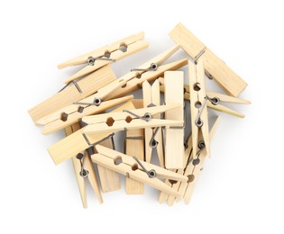 Pile of wooden clothespins on white background, top view