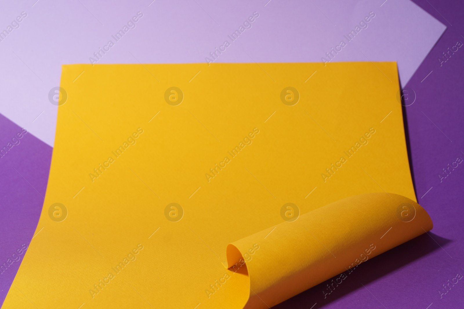 Photo of Different colorful paper sheets on purple background