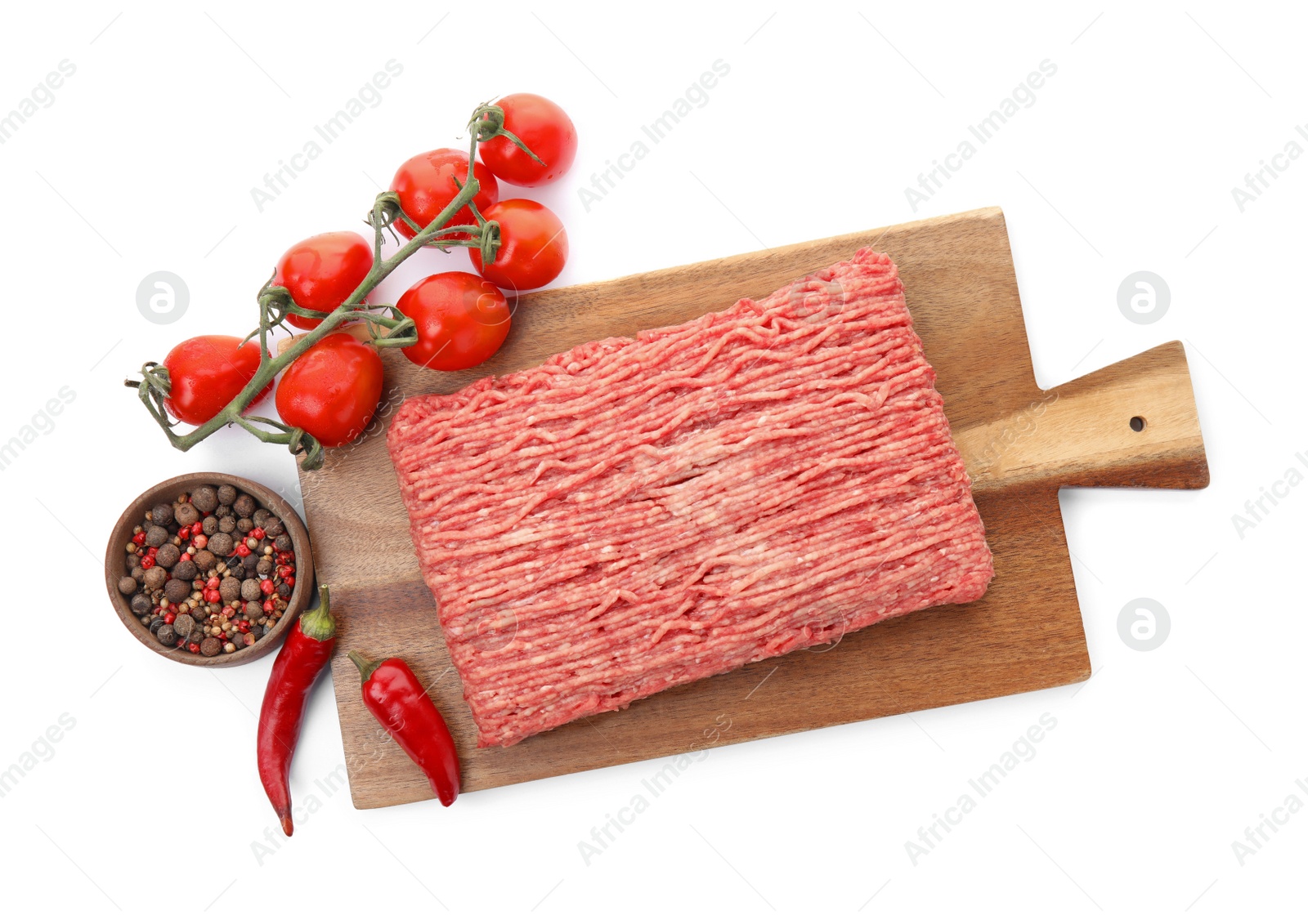 Photo of Wooden board with raw fresh minced meat, tomatoes and other ingredients on white background