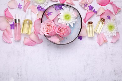 Photo of Flat lay composition with bowl of water and beautiful flowers on light table, space for text. Spa treatment