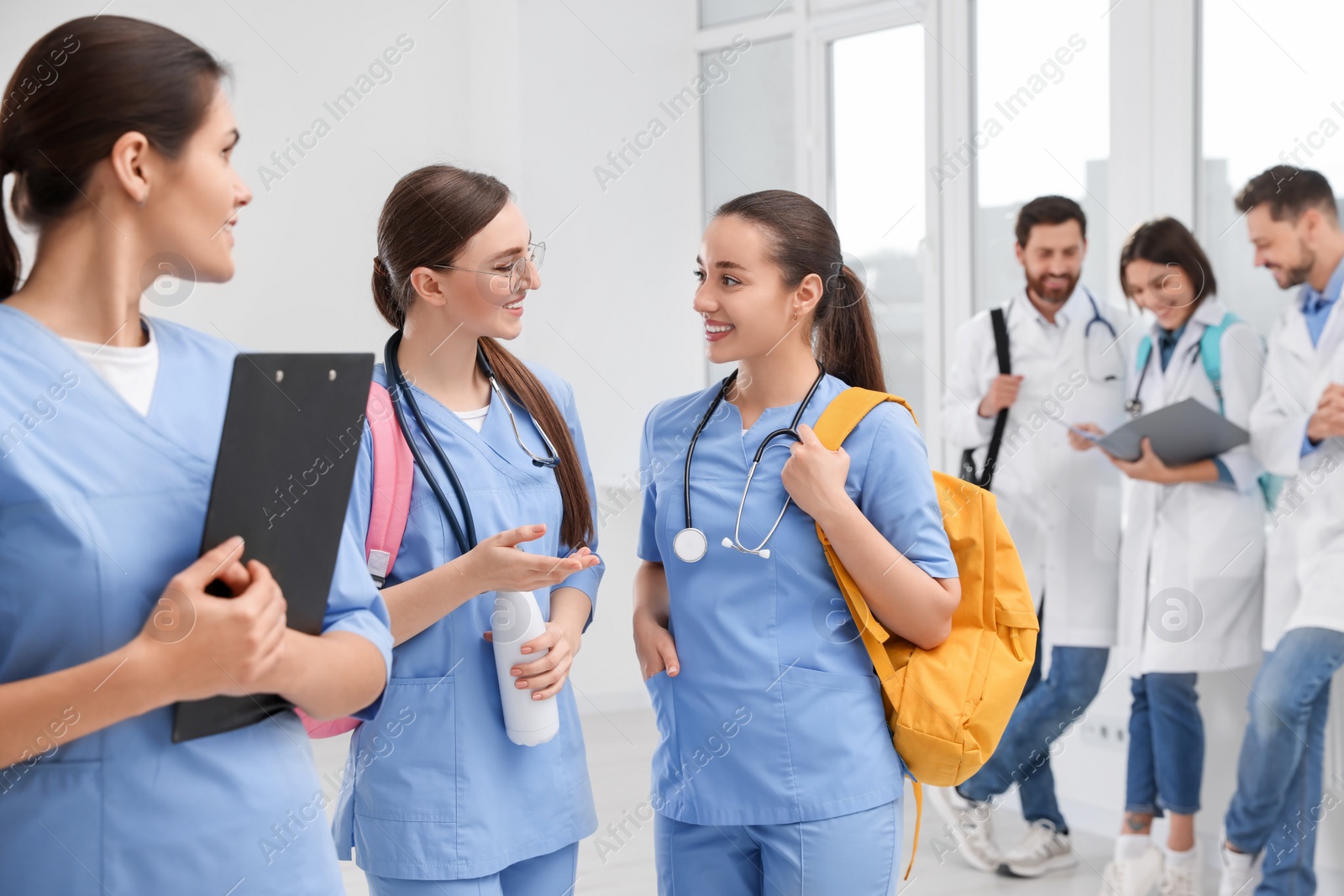 Photo of Team of medical students in college hallway, space for text