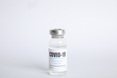 Vial with coronavirus vaccine on white background