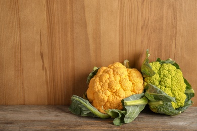 Colorful cauliflower cabbages on wooden table. Healthy food