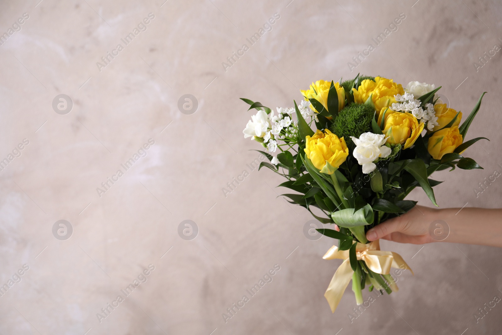 Photo of Woman with bouquet of beautiful peony tulips on beige background, closeup. Space for text