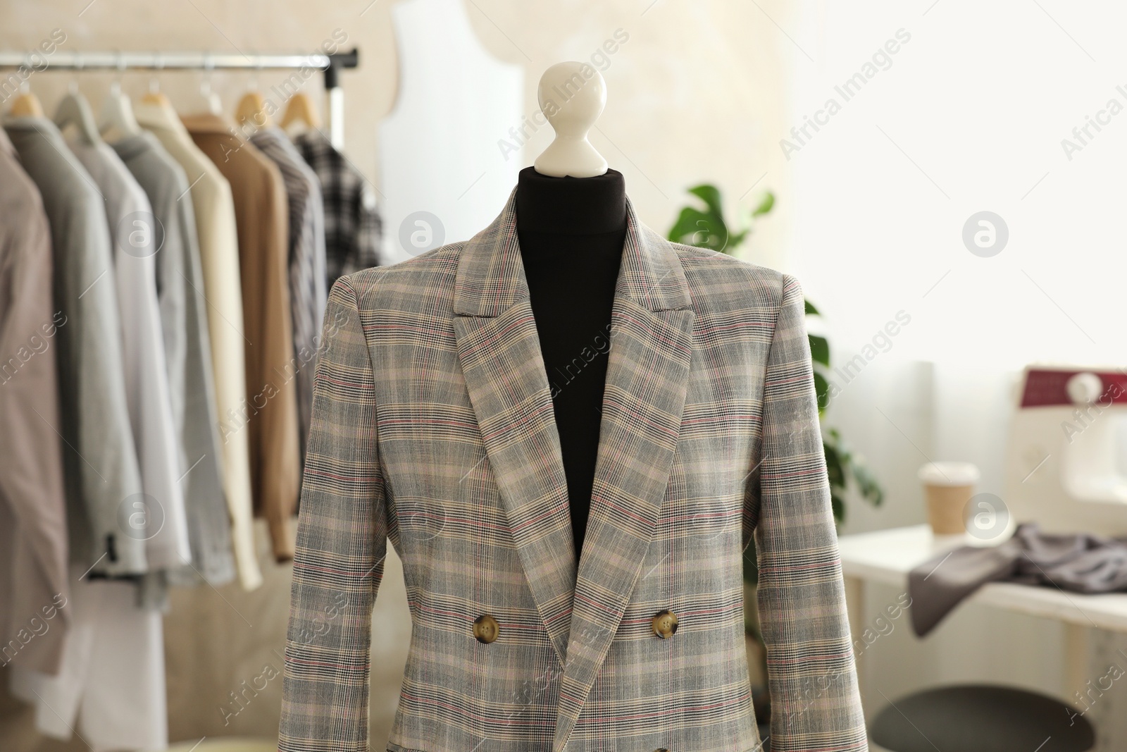 Photo of Mannequin with stylish jacket in tailor shop