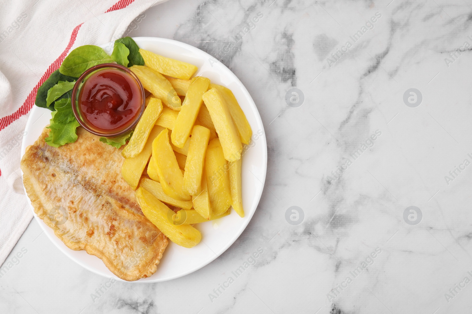 Photo of Delicious fish and chips with ketchup, spinach and lettuce on light marble table, top view. Space for text