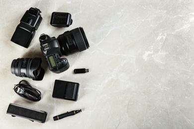 Photo of Flat lay composition with equipment for professional photographer on grey marble table. Space for text