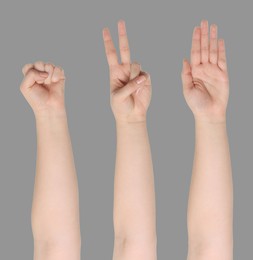 People playing rock, paper and scissors on grey background, closeup