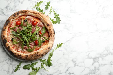 Photo of Tasty pizza with meat and arugula on white marble table, flat lay. Space for text