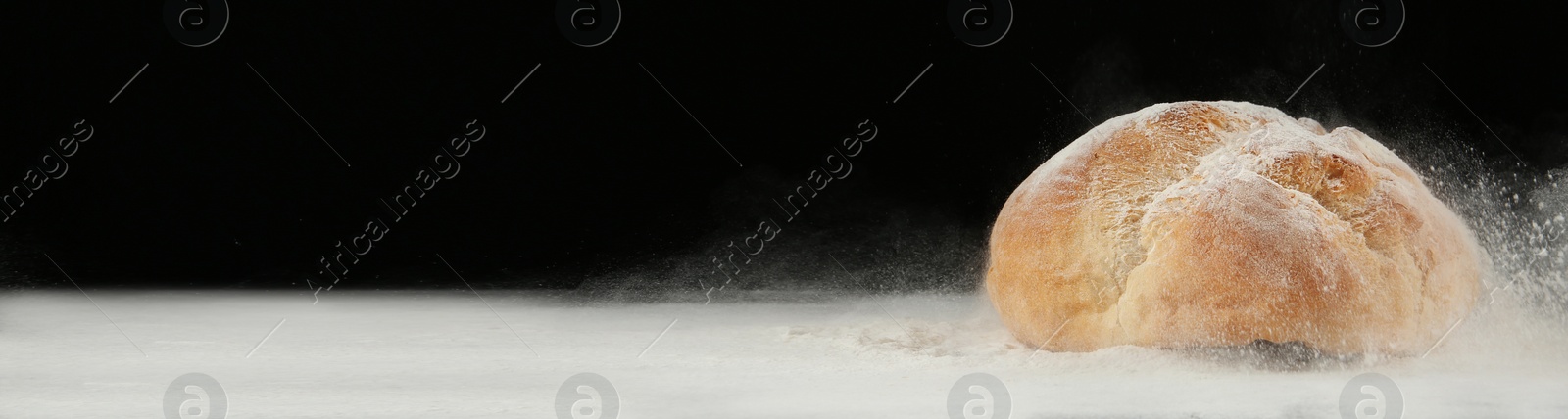 Image of Bread made from wheat dough on table against black background, space for text. Banner design