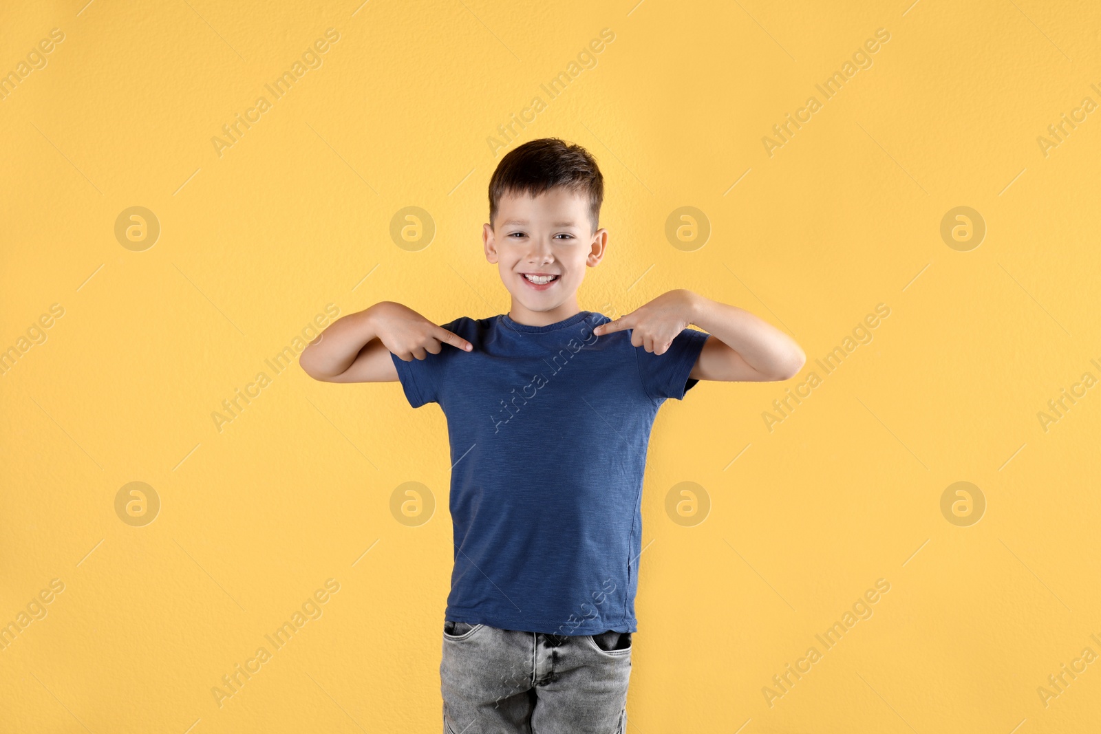 Photo of Little boy in t-shirt on color background. Mock-up for design