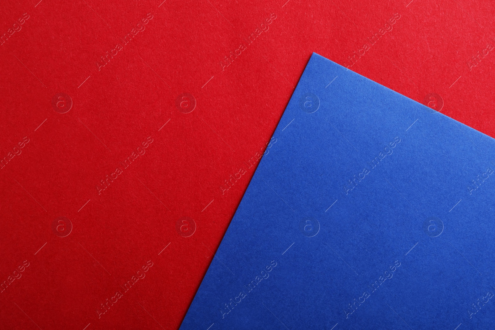 Photo of Blue and red paper sheets as colorful background, top view