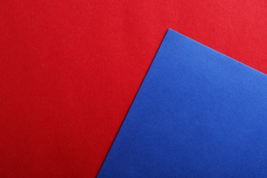 Photo of Blue and red paper sheets as colorful background, top view