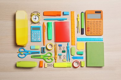 Photo of Different stationery on wooden background, flat lay