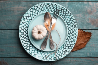 Autumn table setting with pumpkin on blue wooden background, flat lay