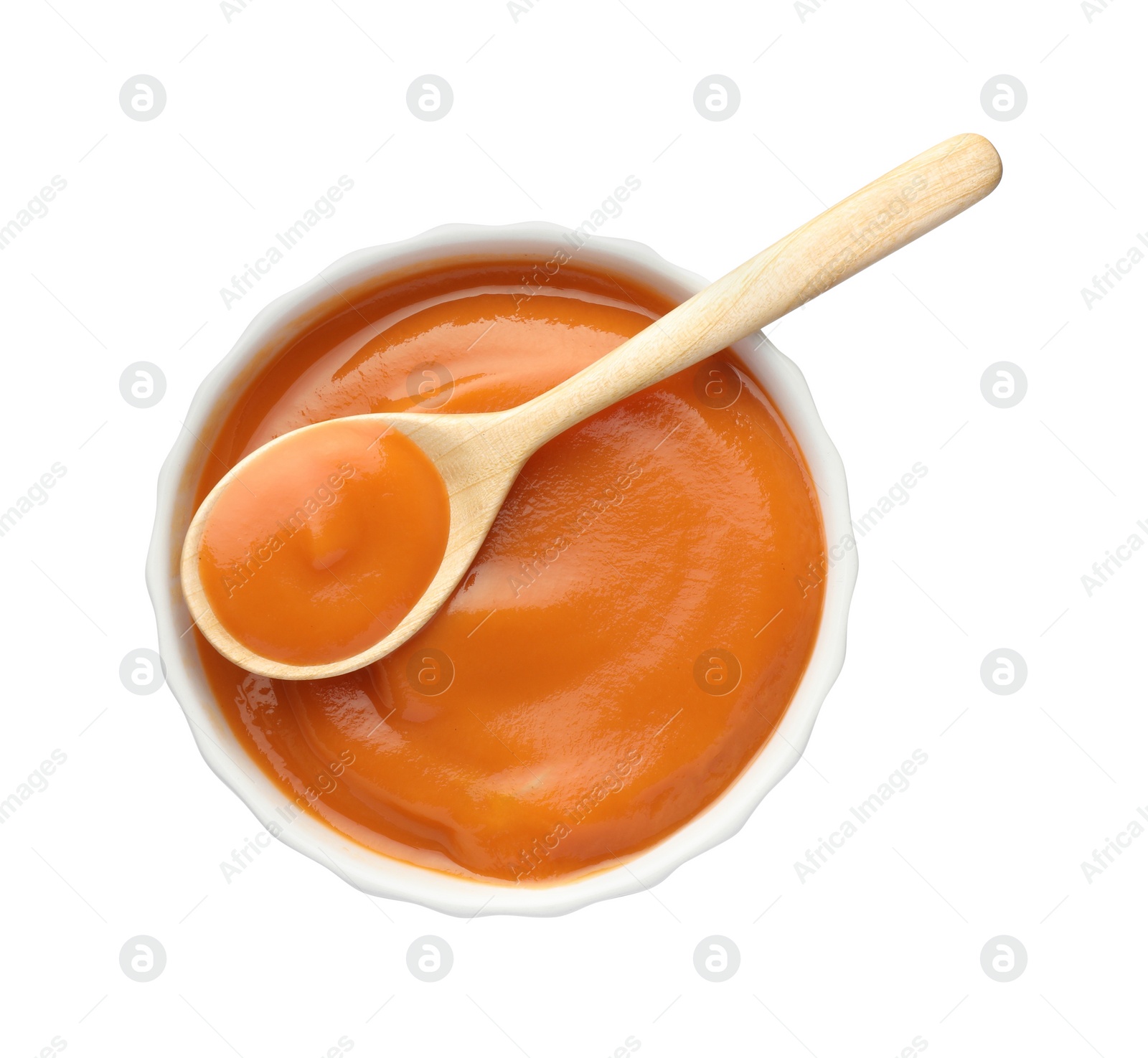Photo of Delicious persimmon jam and spoon in bowl isolated on white, top view