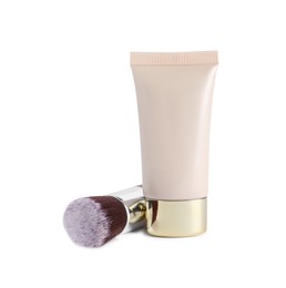 Photo of Tube of skin foundation and brush on white background. Makeup product