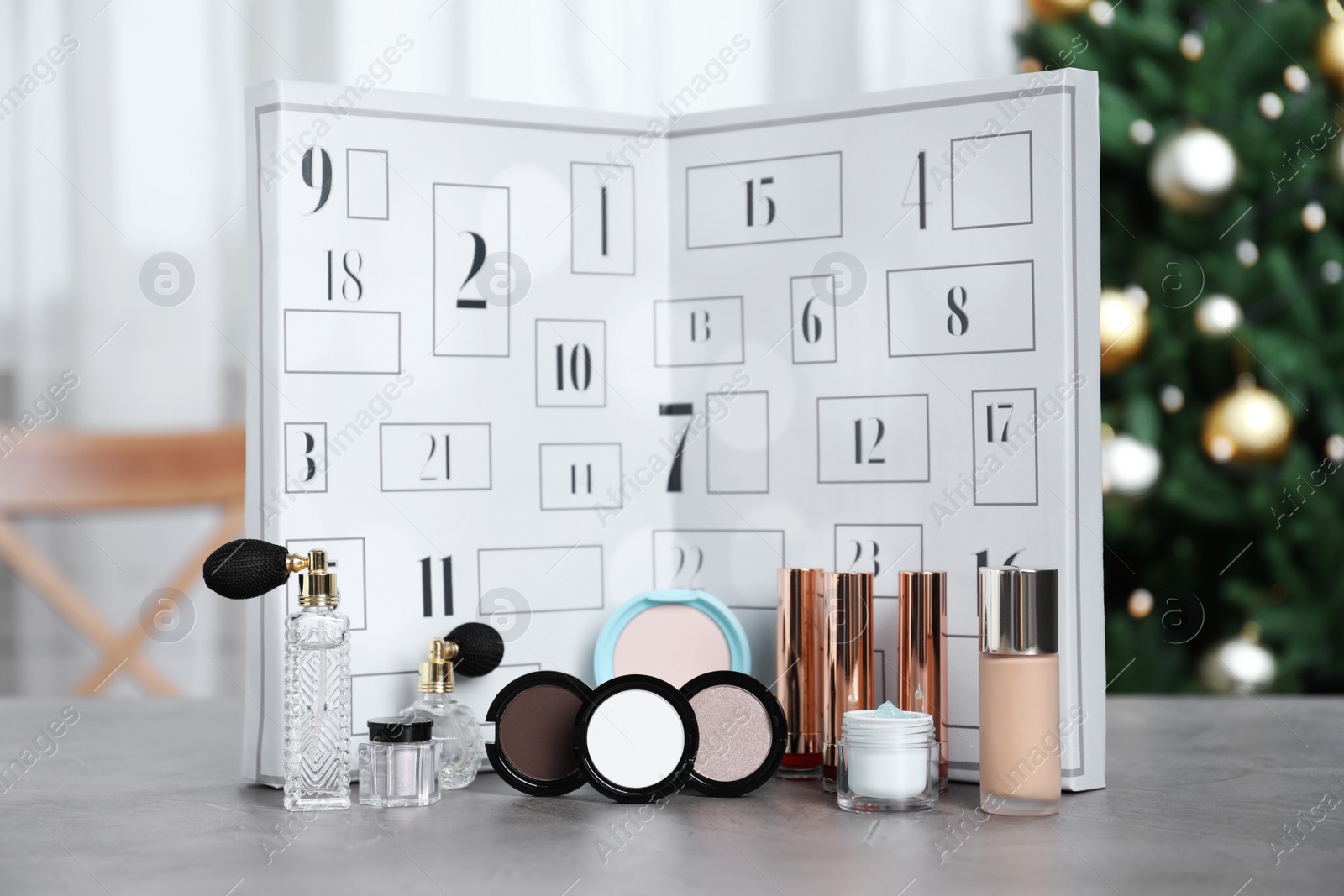 Christmas advent calendar with perfumes, skin care and decorative cosmetics on table Photo of Christmas advent calendar with perfumes, skin care and decorative cosmetics on table