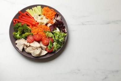 Photo of Balanced diet and healthy foods. Plate with different delicious products on white marble table, top view. Space for text