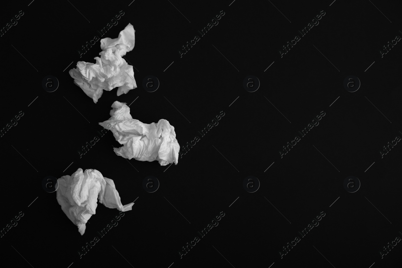 Photo of Used paper tissues on black background, flat lay. Space for text