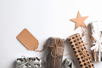 Photo of Beautiful gift boxes with tags on white background, top view