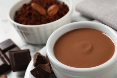 Photo of Yummy hot chocolate in cup on table, closeup. Space for text