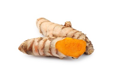 Photo of Fresh whole and cut turmeric roots isolated on white