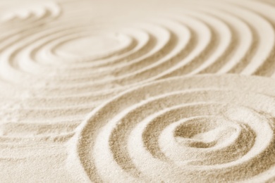 Photo of Zen garden pattern on sand. Meditation and harmony