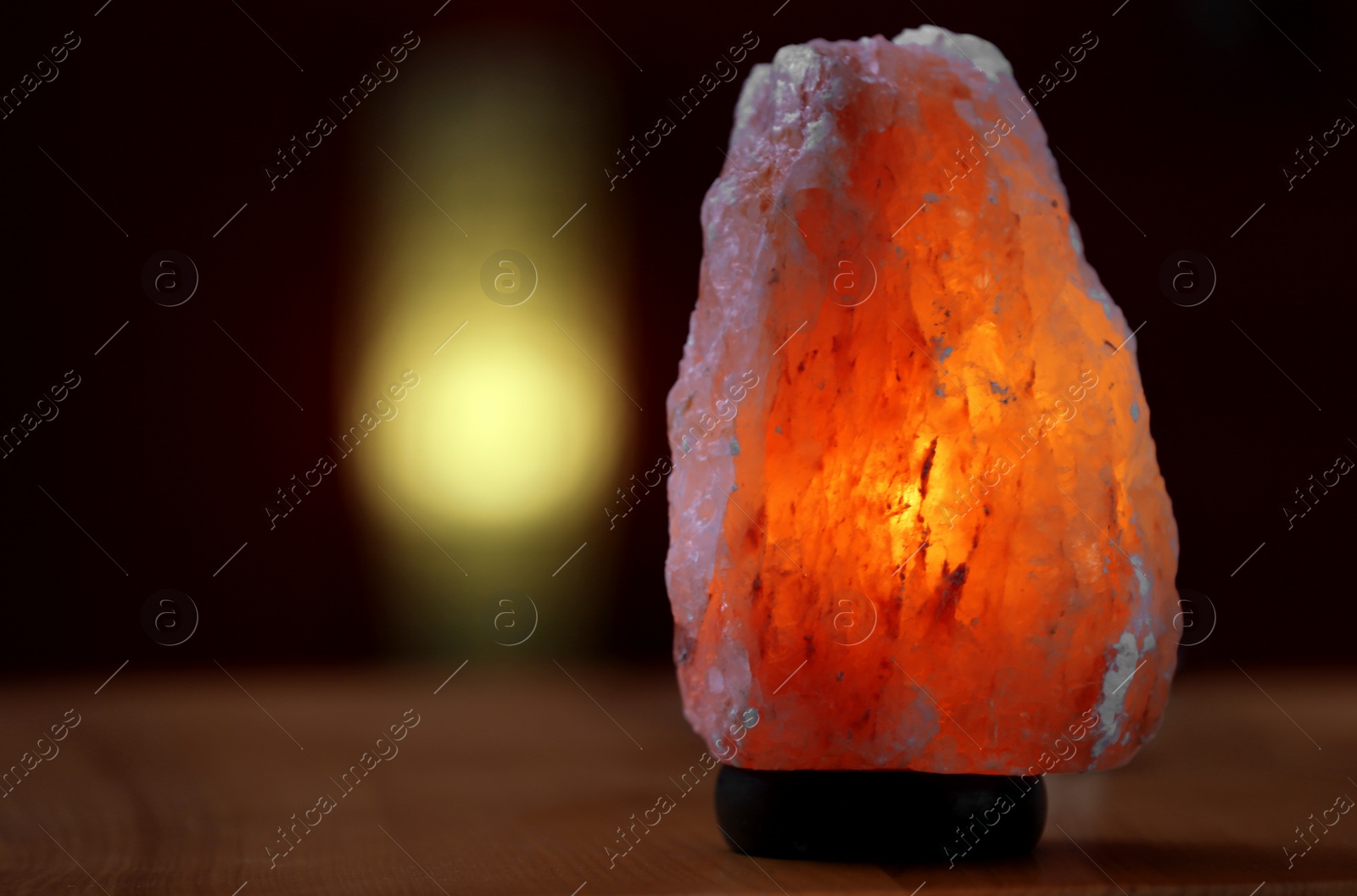 Photo of Himalayan salt lamp on table indoors, space for text