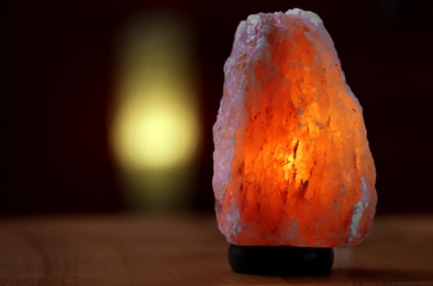 Photo of Himalayan salt lamp on table indoors, space for text