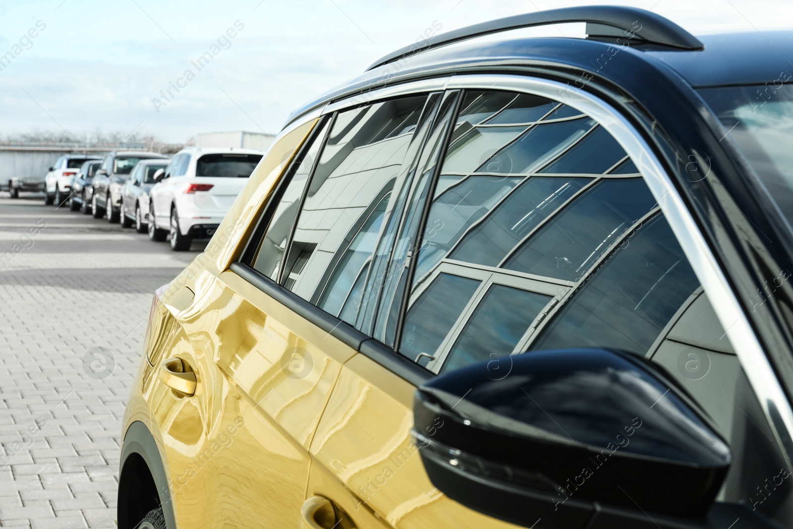 Photo of Modern car with tinting foil on window outdoors, closeup