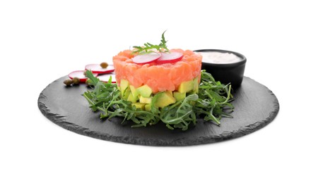 Photo of Tasty salmon tartare with radish, avocado, arugula and sauce isolated on white