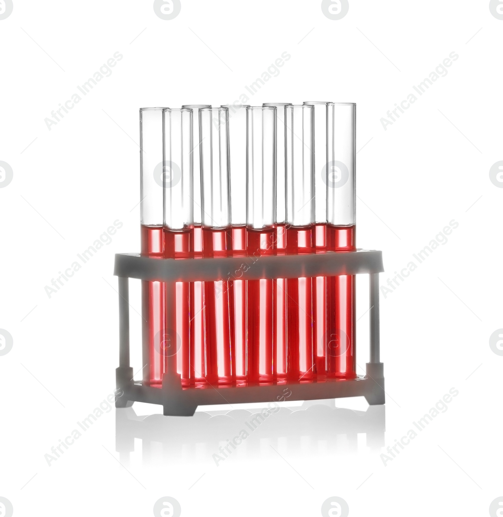 Photo of Test tubes with liquid samples in rack on white background. Chemistry glassware