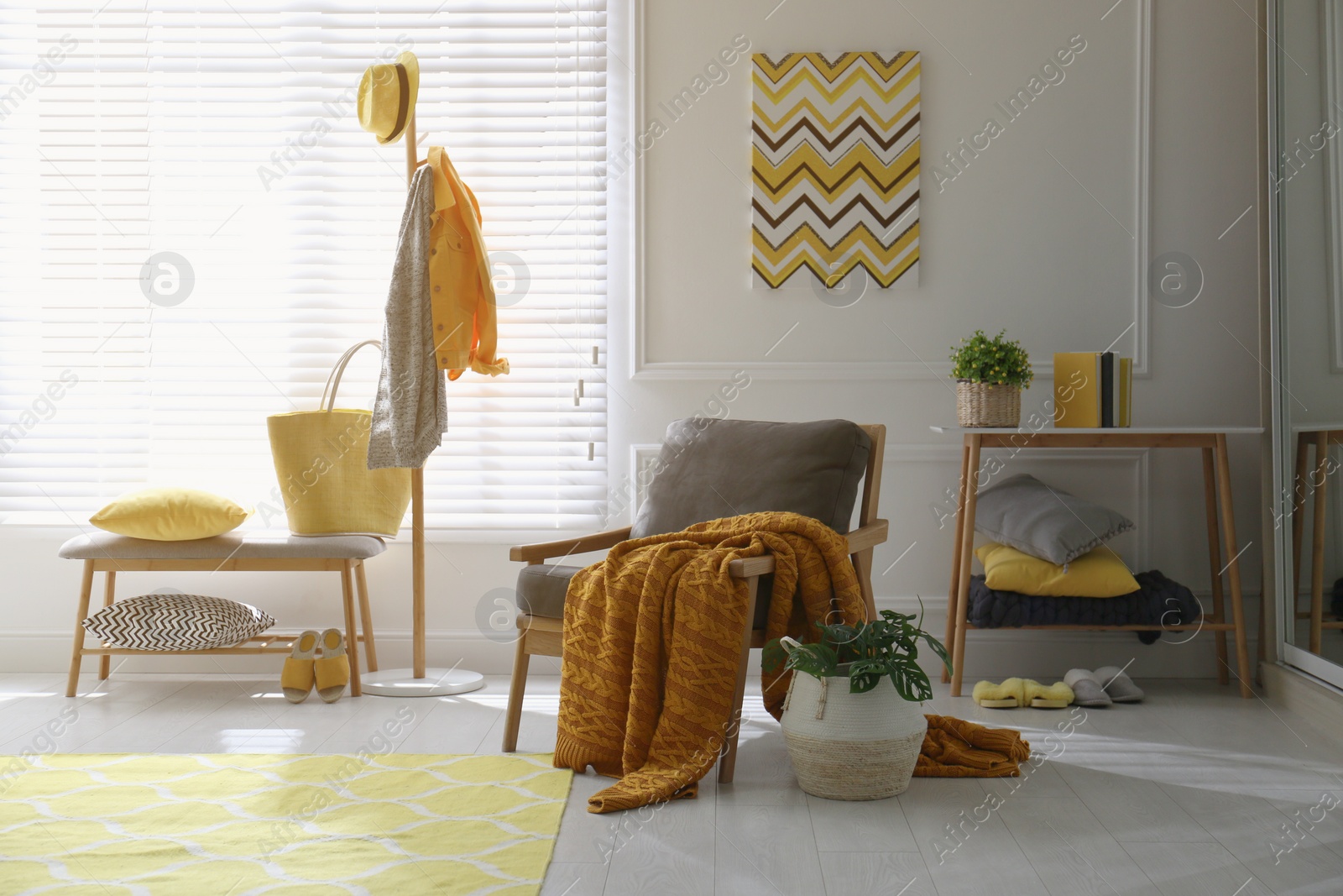 Photo of Comfortable armchair with plaid in living room. Interior design