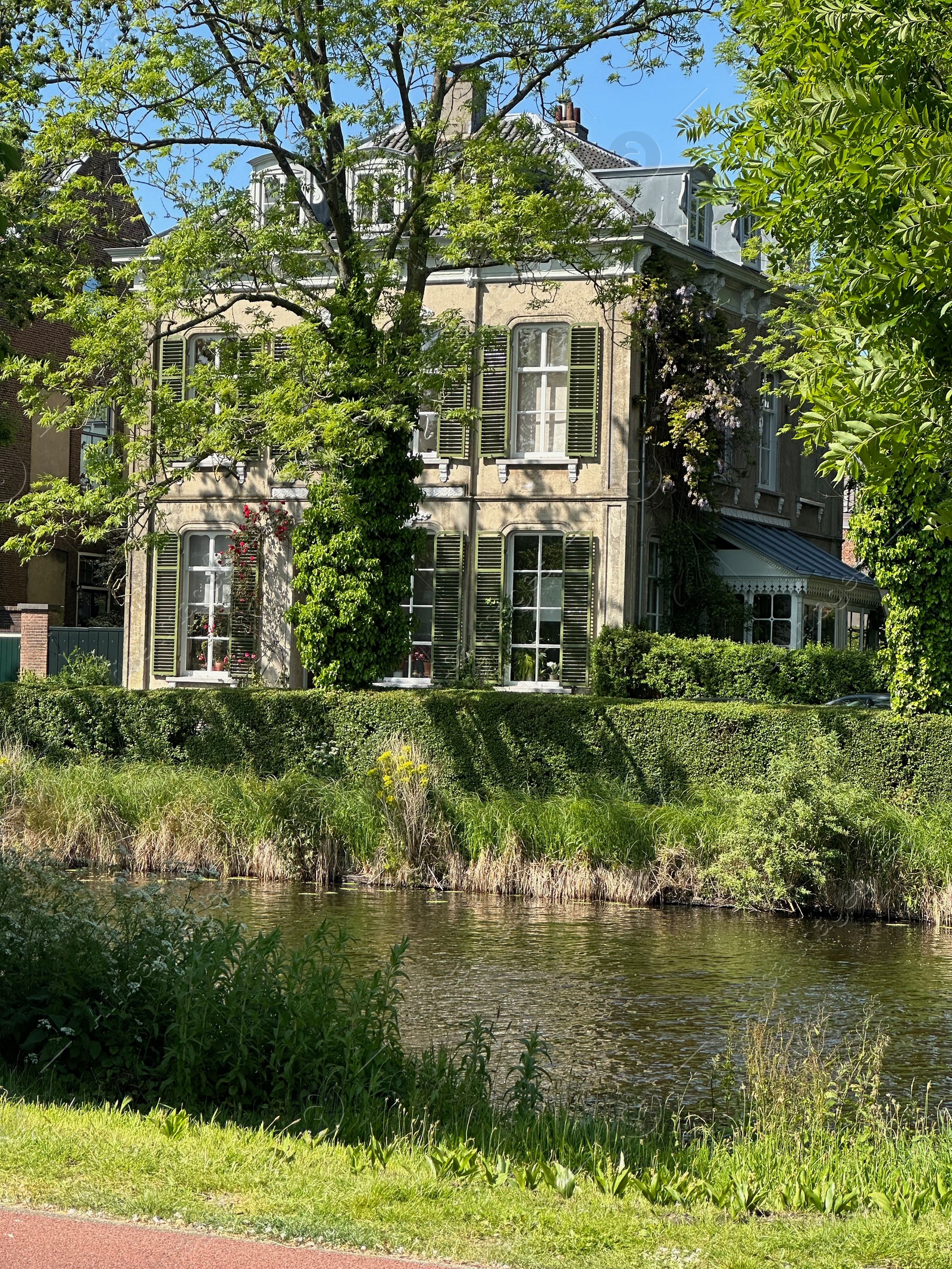 Photo of Beautiful view of building near river outdoors on sunny day