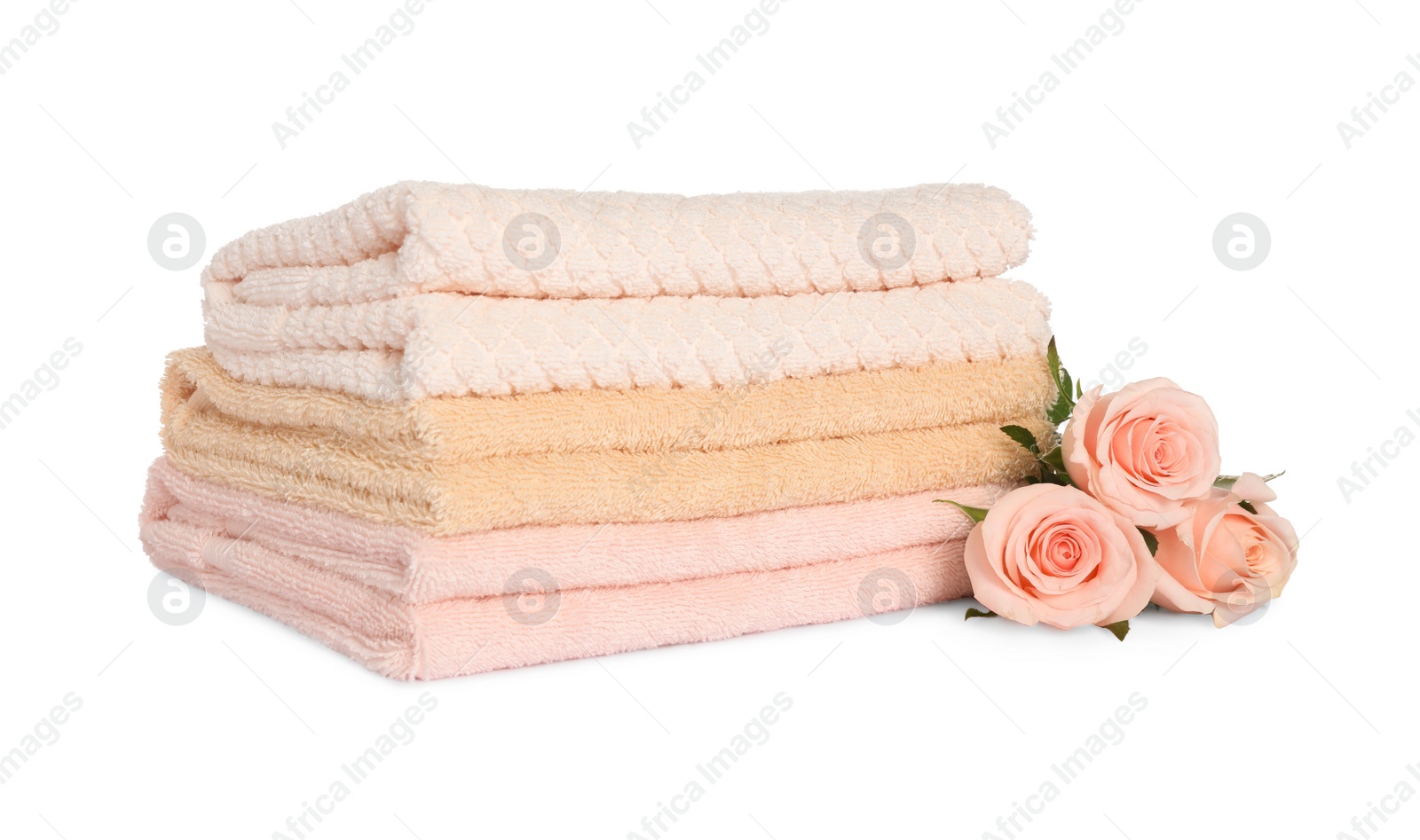 Photo of Stack of clean soft towels with flowers isolated on white