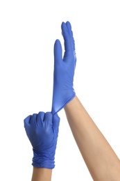 Photo of Woman putting on blue latex gloves against white background, closeup of hands