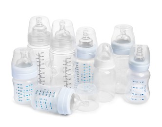 Many different empty feeding bottles for baby milk on white background