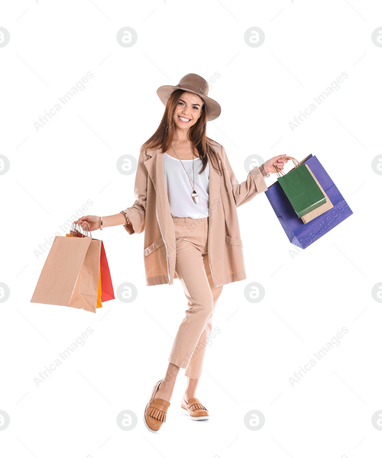 Photo of Young woman with shopping bags on white background