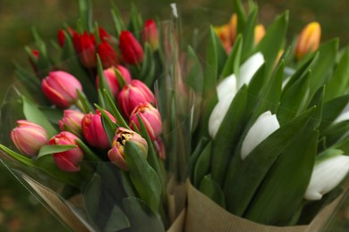 Photo of Beautiful bouquets of colorful tulips outdoors, closeup